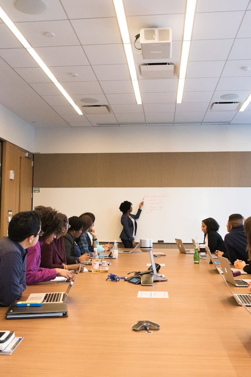 Business meeting with diverse team discussing projects in a modern conference room.